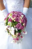 Bridal in beautiful white dress, with the colorful and beautiful bridal bouquet