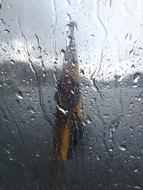 Swedish flag through a wet window
