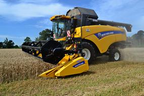 rural machinery harvests crops on the field