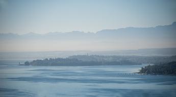 distant Mainau Island on Lake Constance at foggy morning, germany