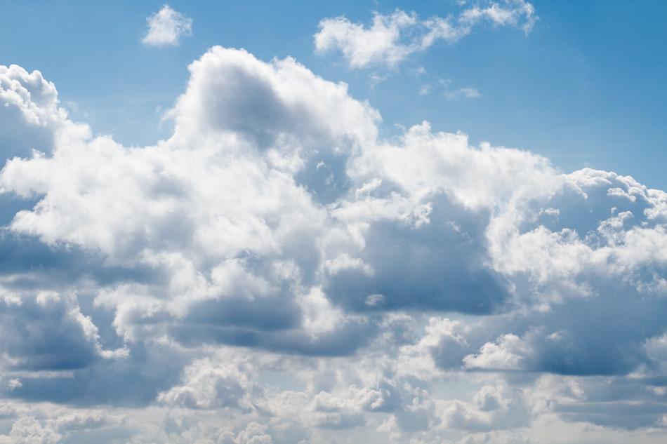 large cloud shapes on blue sky