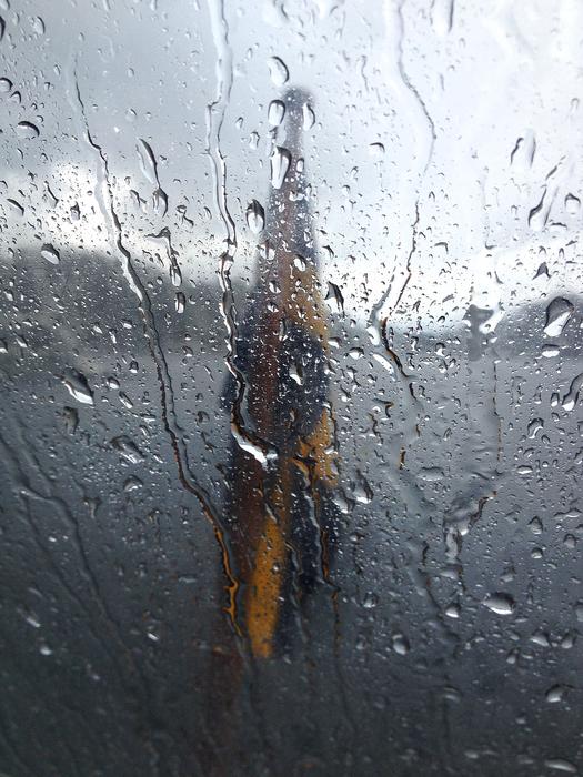 Swedish flag through a wet window