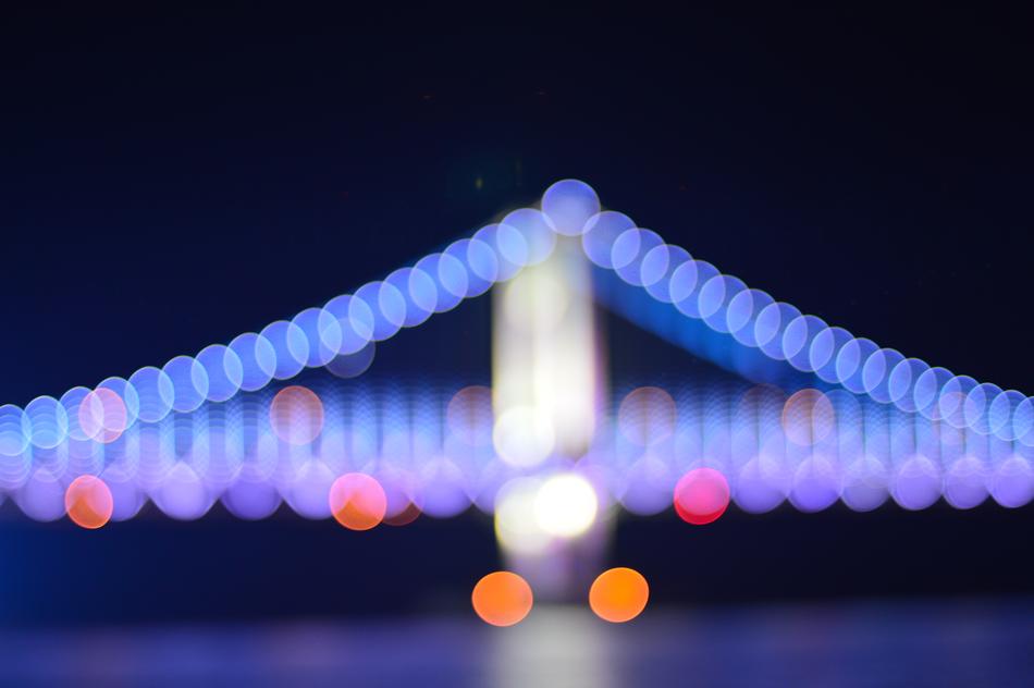 Night illumination of the bridge in multicolored lights