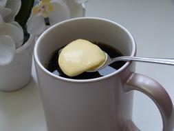 spoonful of cream with coffee