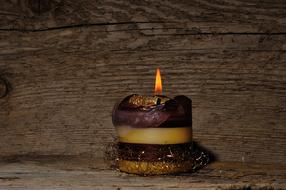 burning Candle at Wood background