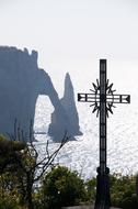 metal cross on the shore near the sea in Sweden