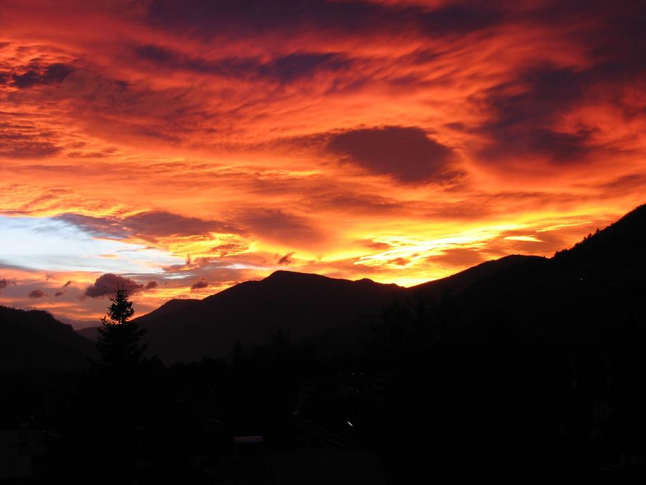 Sunset on the clouds on top of the mountains