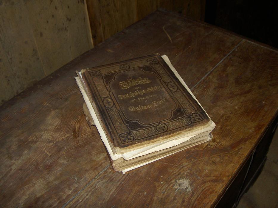 An antique book lying on the bench