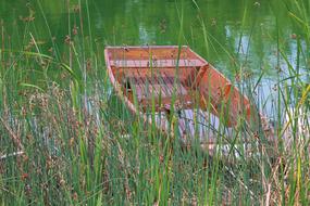 Stranded boat in pond