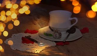 white tea cup and key at dusk