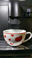 white cup with hearts