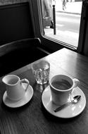 A cup of coffee on a wooden table in a cafe