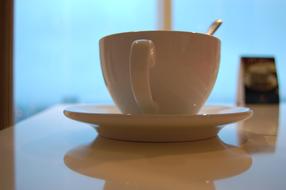 white cup with spoon