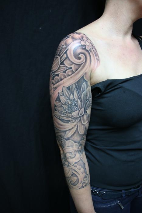 Girl in black dress, with the beautiful tattoo sleeve on the arm