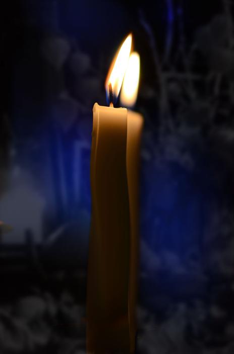 burning Candle near mirror with reflection