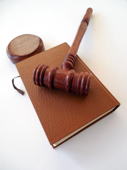 wooden gavel on closed book