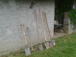 Tools for the garden standing near the wall