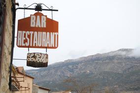restaurant sign withmountain as backdrop