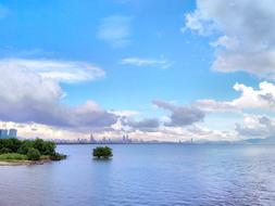 White clouds over the sea near the city