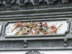 floral design with a bird on the building