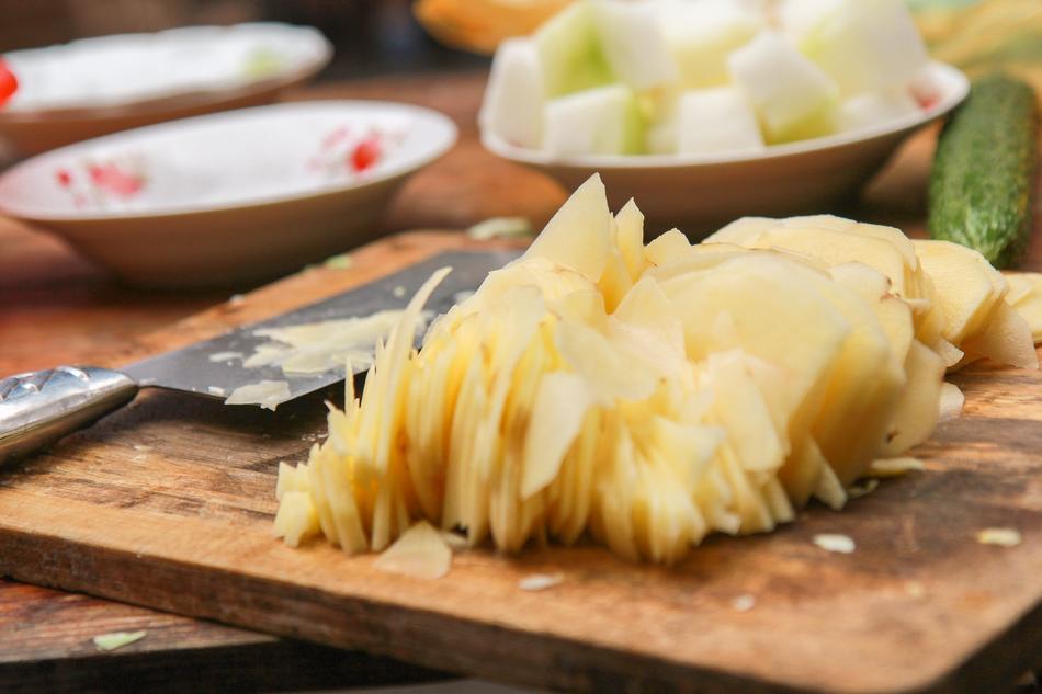 cutting potato on chopboard