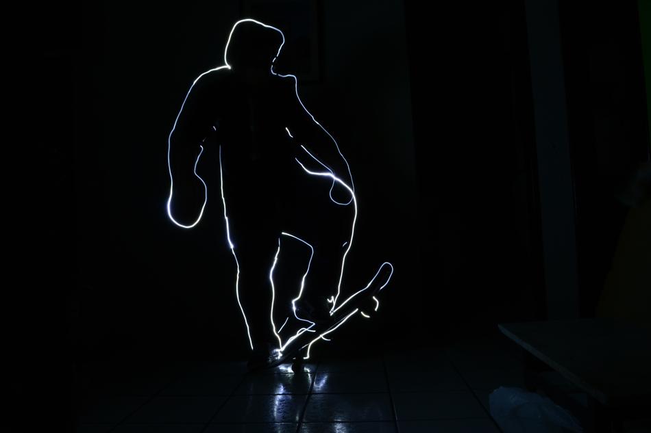 Light silhouette of a guy on a skateboard