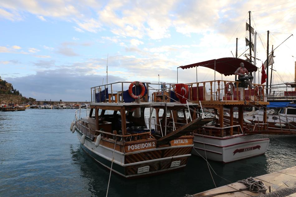 man sitting aboard a parked boat