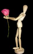 wooden doll with bright rose