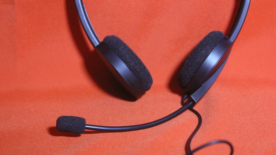 Headphones with microphone on orange background