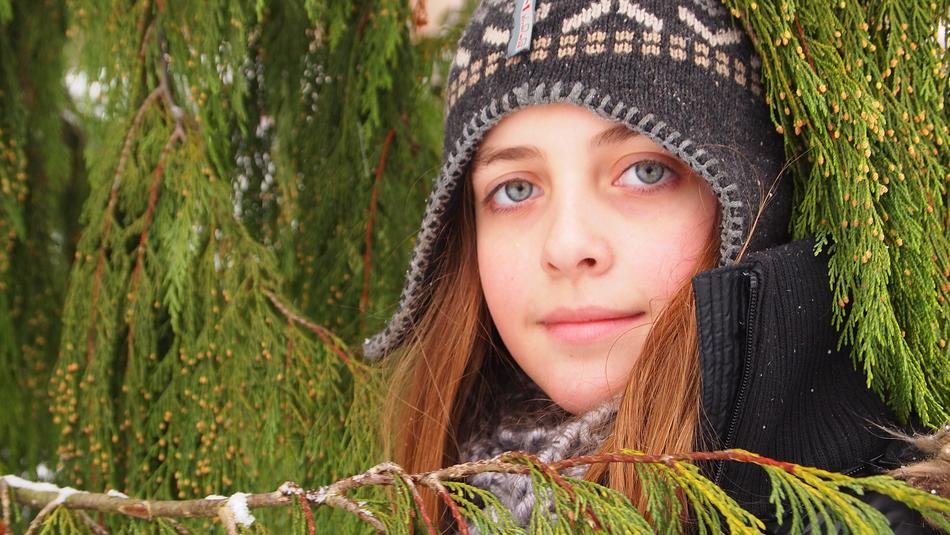face of a girl with blue eyes in a hat