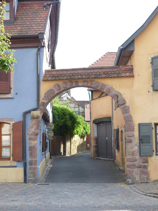 archway passing into the street courtyard