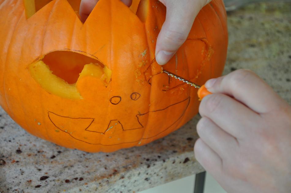 Carving a face on a pumpkin