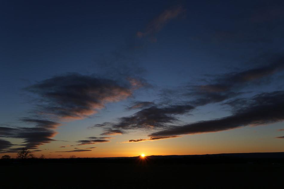 The sun is disappearing over the horizon