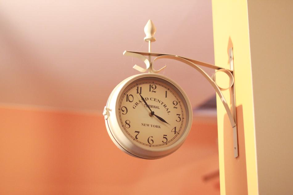 hanging clock on the building