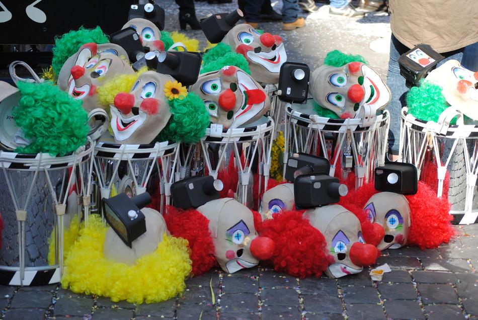 Clown masks scattered on the floor and drums