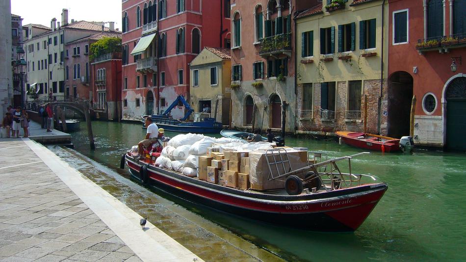 ship with cargo sailing down the city canal