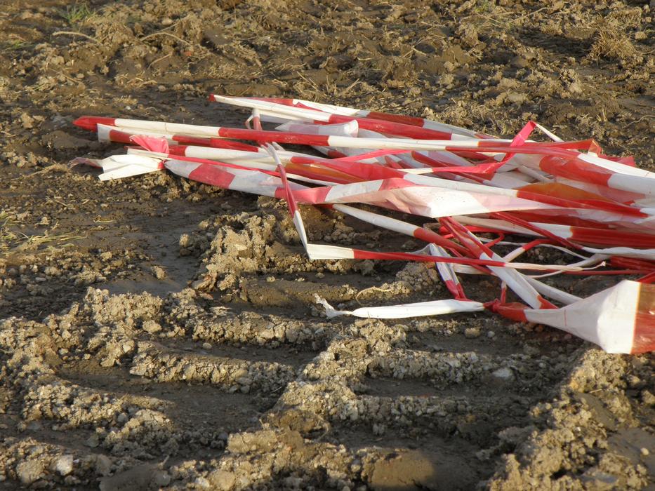 Red and white ribbons lying on the ground