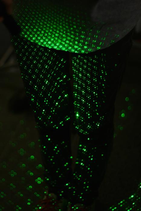 Green light from the laser on the wall