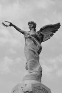 old sculpture of an angel with a wreath