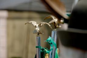 golden eagle on the end of a green iron handle