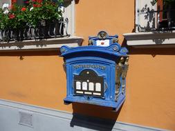 blue iron mailbox on the house