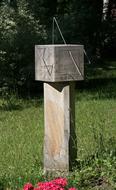 stone old clock in the sun