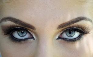 woman painted eyes are shiny