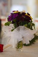 dark flowers in a wedding bouquet on a blurred background