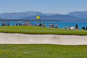 golf course by the lake with people