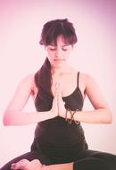 girl doing yoga on a pink background
