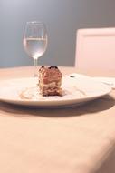 piece of sweet cake by the glass