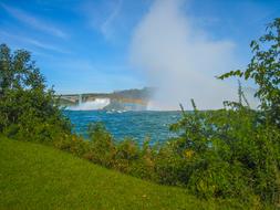 bright rainbow against a waterfall