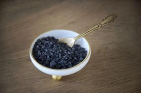 black crystalline salt in a plate