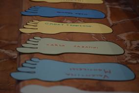 colored footprints on a wooden bench
